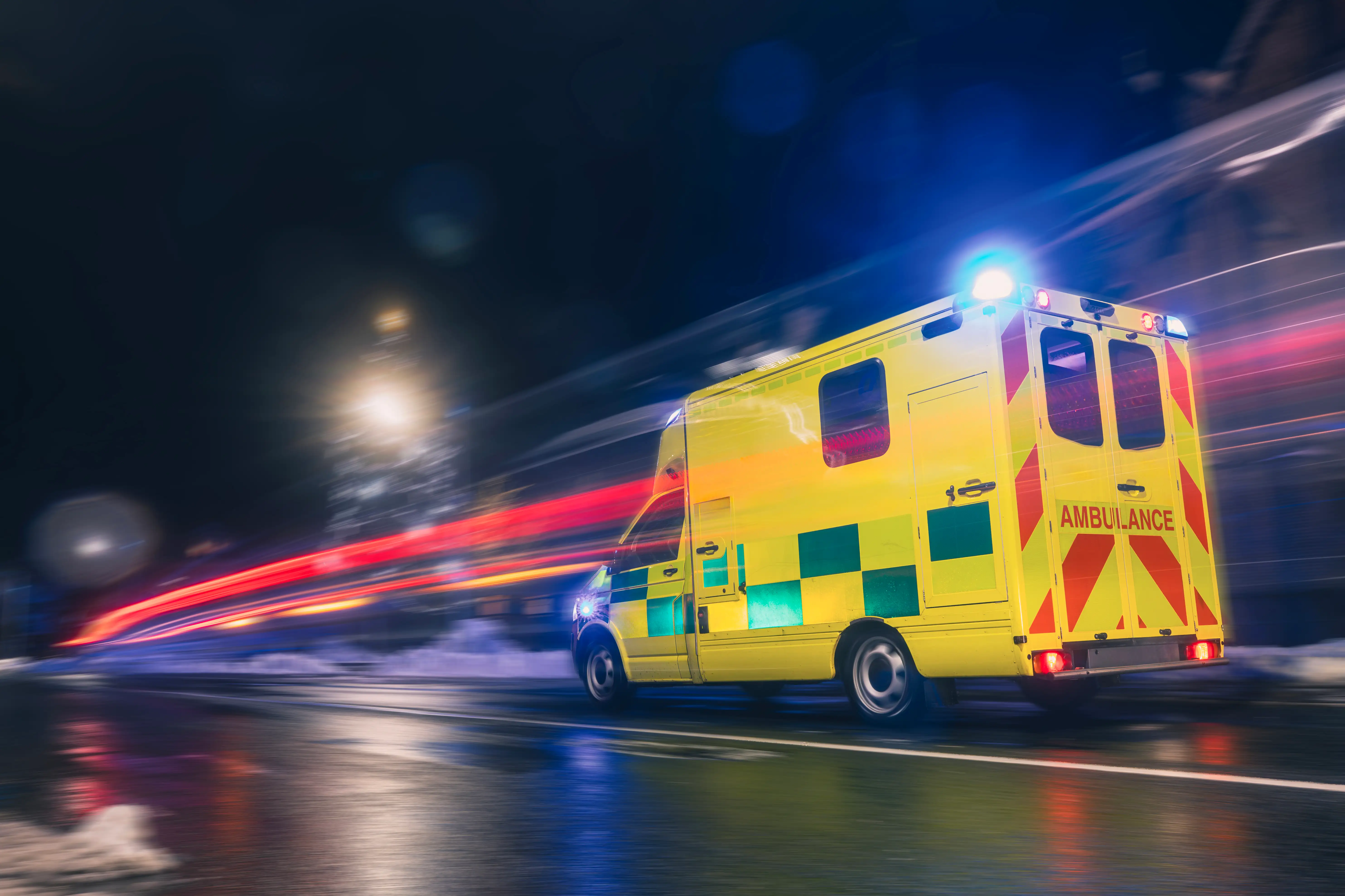 North West C1 ambulance training vehicle C1 ambulance training vehicle travelling through city streets at night